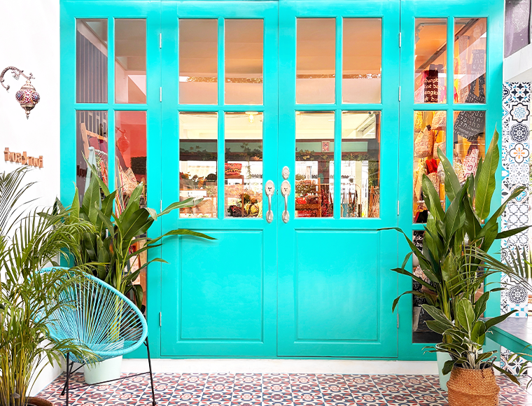 The Toanoi House entrance with plants and a wooden bench